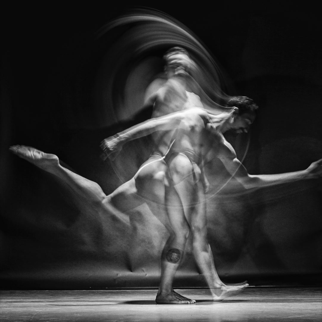 A dancer captured through layered movement in black and white